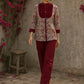 Elegant maroon floral top with intricate maroon pleats, high neckline, covered buttons, and coordinating sleeve cuffs.