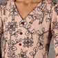 Beige traditional printed dress with rich maroon accents.