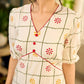 Soft off-white block printed rayon dress with intricate all-over hand block printed checks and florals, a gently gathered yoke, and rich red accents for a refined, elegant everyday look.