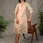 Peach Kalamkari-inspired shirt dress with soft beige accents.