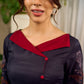 Elegant black Kalamkari-inspired dress with deep maroon accents and graceful floral motifs.