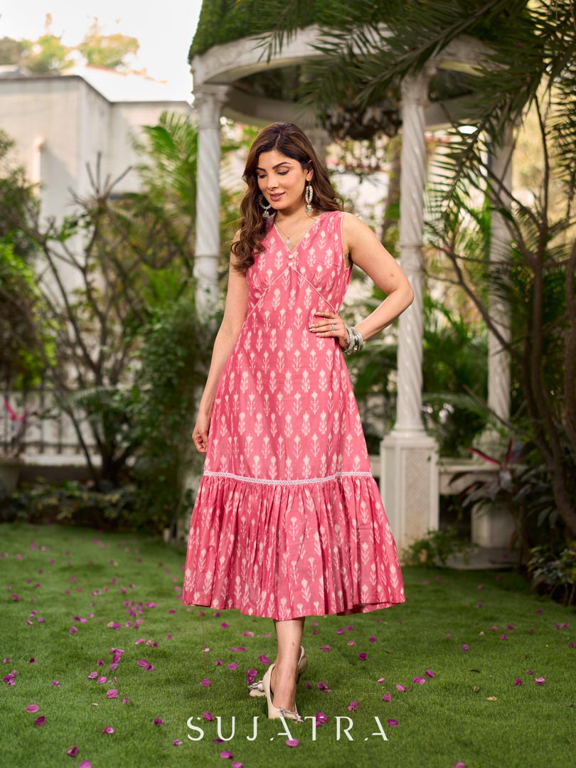 Graceful pink Ikat long dress accented in white, designed with gathered detailing at the fall and a clean sleeveless finish