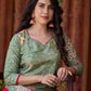 Soft green printed kurta with vibrant floral motifs, highlighted with hand embroidery and bright magenta accents.