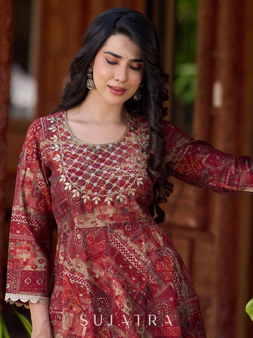 Exquisite deep maroon printed kurta with a graceful bias silhouette, intricate handwork on the yoke, and scalloped sleeve detailing.