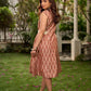 Chic champagne beige Ikat dress elevated with Hakoba accents, a relaxed drop-shoulder fit, mandarin neckline, and fluid side gathers detailed with Hakoba flaps.