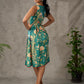 Green peacock motif printed dress with straight neckline and orange accents