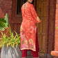 Elegant orange floral printed kurta with hand-embroidered sequin and cut dana detailing on the yoke and rich maroon accents.