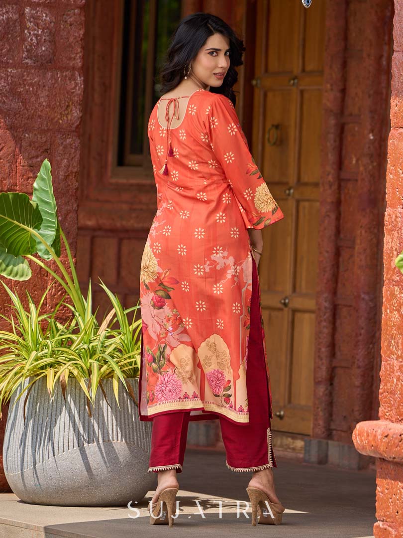 Elegant orange floral printed kurta with hand-embroidered sequin and cut dana detailing on the yoke and rich maroon accents.