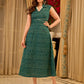 Teal Printed Sleeveless Crossover Midi Designed in a rich teal print, highlighting a crisp notched collar, defined wrap waist, and a fluid flared silhouette.