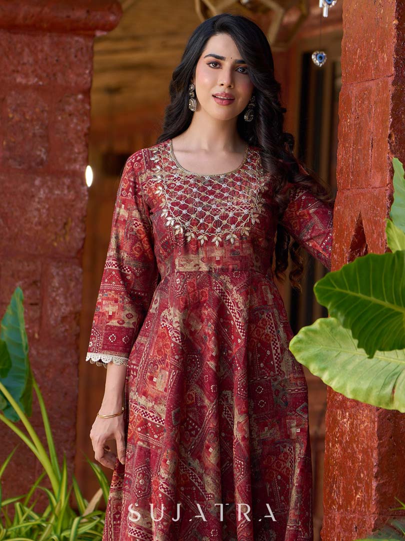 Exquisite deep maroon printed kurta with a graceful bias silhouette, intricate handwork on the yoke, and scalloped sleeve detailing.