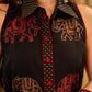 Statement black sleeveless shirt dress showcasing elephant-inspired prints and polka dots, highlighted with maroon accents.