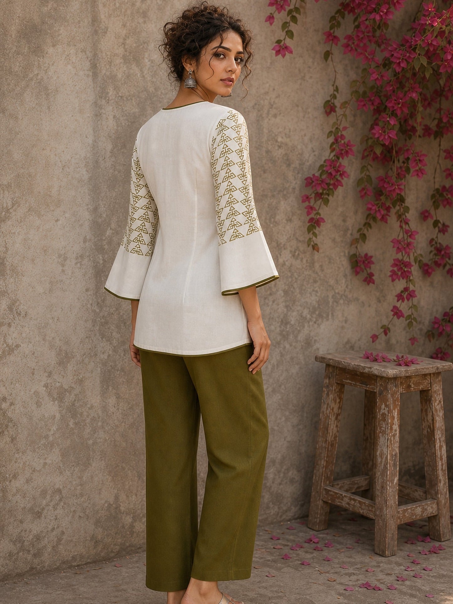 Contemporary off white and olive hand block print top features subtle geometric motifs, airy bell sleeves, and effortless elegance for versatile everyday styling.