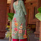 Soft green printed kurta with vibrant floral motifs, highlighted with hand embroidery and bright magenta accents.