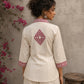 Vibrant ivory hand block print shirt featuring geometric motifs, magenta accents, and a contemporary silhouette inspired by traditional craftsmanship.