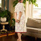 Soft off-white block printed rayon dress with intricate all-over hand block printed checks and florals, a gently gathered yoke, and rich red accents for a refined, elegant everyday look.