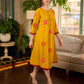 Mustard block printed pintuck dress with hand block red and pink vine floral motifs, accented with red and olive details for a rich, elegant look.