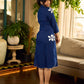 Navy blue apple-cut shirt dress with white floral hand block motifs, conceptually placed and finished with clean white edging and red accents for a refined, contemporary look.