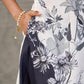 White and black floral dress with pearl embellishments and black accents.