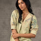 Soft green Kalamkari printed collared dress with centre pleat detailing.