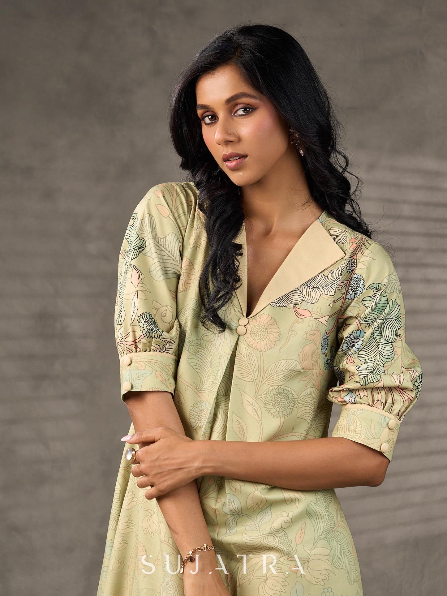 Soft green Kalamkari printed collared dress with centre pleat detailing.