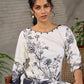 White and black floral dress with pearl embellishments and black accents.