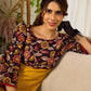 Mustard Kalamkari dress with an asymmetrical yoke and puffed sleeves.