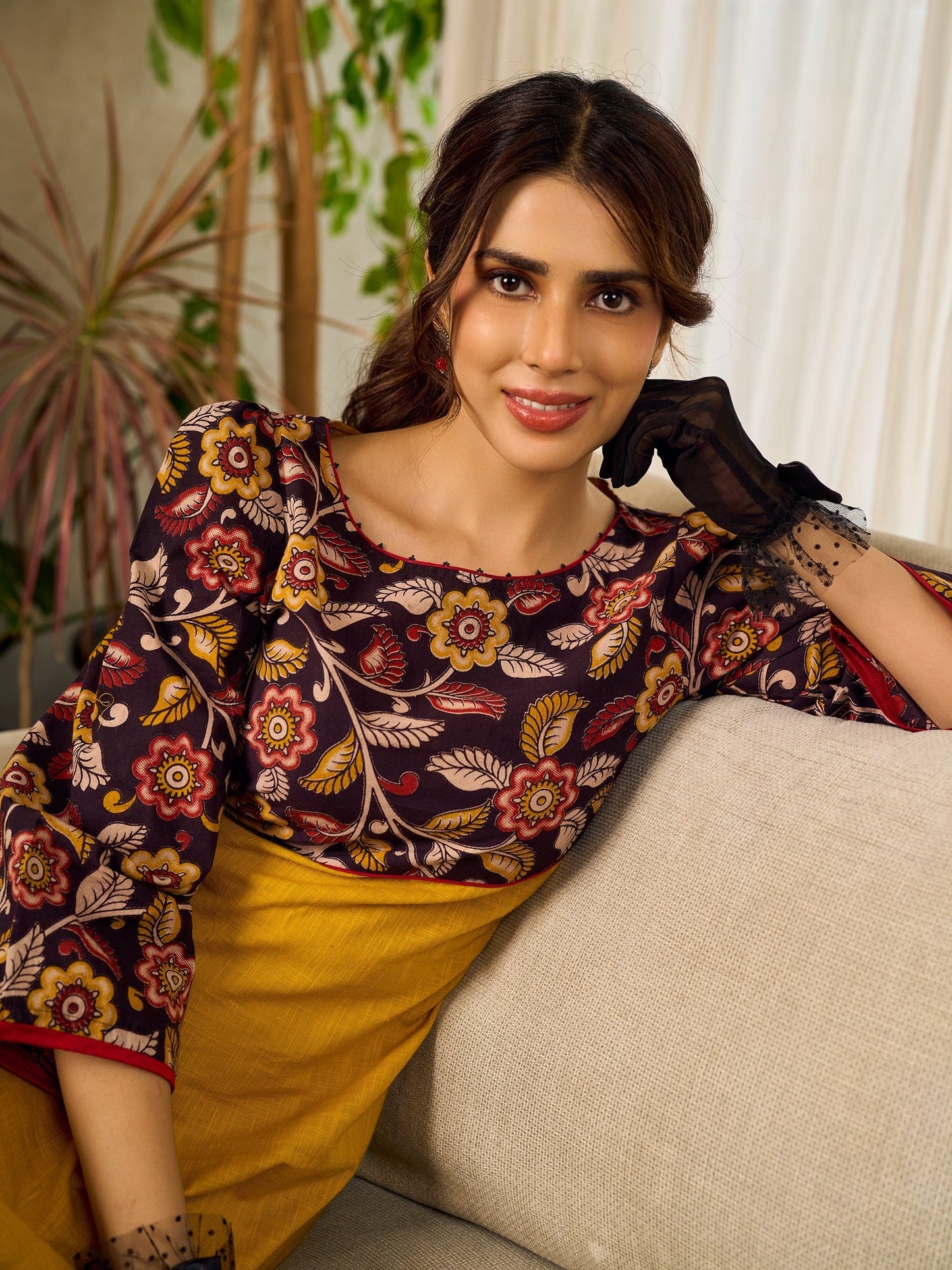 Mustard Kalamkari dress with an asymmetrical yoke and puffed sleeves.
