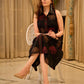 Statement black sleeveless shirt dress showcasing elephant-inspired prints and polka dots, highlighted with maroon accents.
