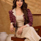 Smart maroon Ikat jacket featuring gathered sleeves, a cream notch collar, and subtle accents, creating a defined, structured silhouette suited for polished corporate wear.