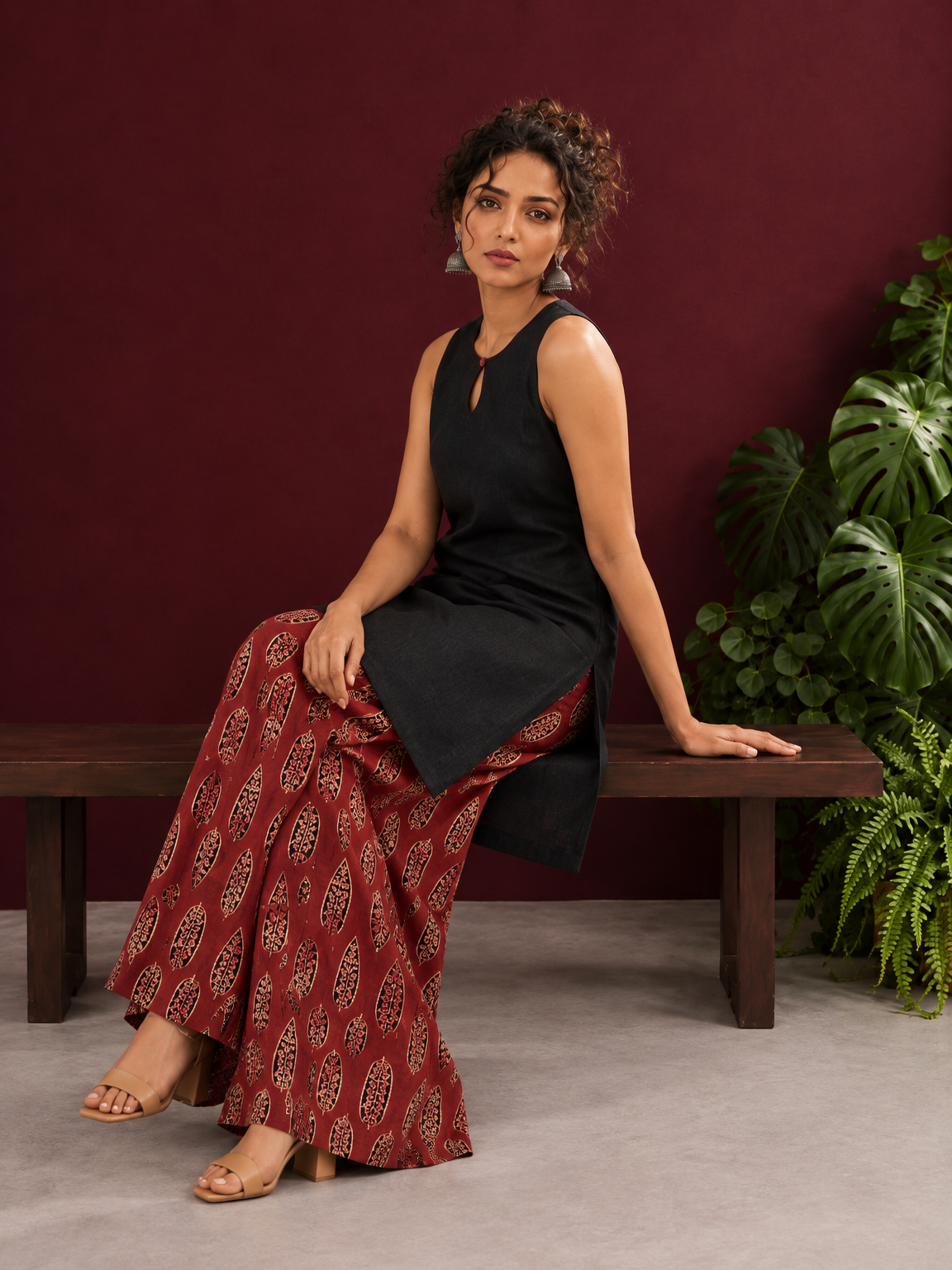 Black Sleeveless Keyhole Neck Tunic Co-Ord Set with Maroon Ajrakh Printed Cotton Farshi Salwar — seated