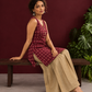 Maroon Printed Cotton Sleeveless Co-Ord Set with Polka Dot Motifs and Pleated Beige Farshi Salwar — seated