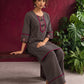 Classic Black & Beige Ajrakh Striped Cotton Co-Ord Set with Ikat Panel Neckline and Maroon Trim Details — seated
