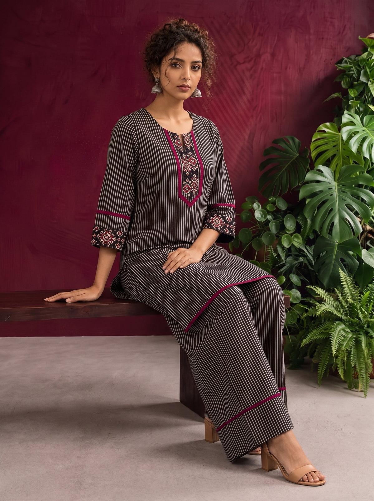 Classic Black & Beige Ajrakh Striped Cotton Co-Ord Set with Ikat Panel Neckline and Maroon Trim Details — seated