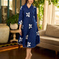 Navy blue apple-cut shirt dress with white floral hand block motifs, conceptually placed and finished with clean white edging and red accents for a refined, contemporary look.