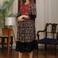 Black ajrakh flared dress with zari work and georgette hemline
