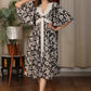 Floral print V neck gathered dress with attached belt and coin embellishments