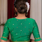 Emrald green cotton silk blouse with overall mirror embroidery highlighted with banarasi lace