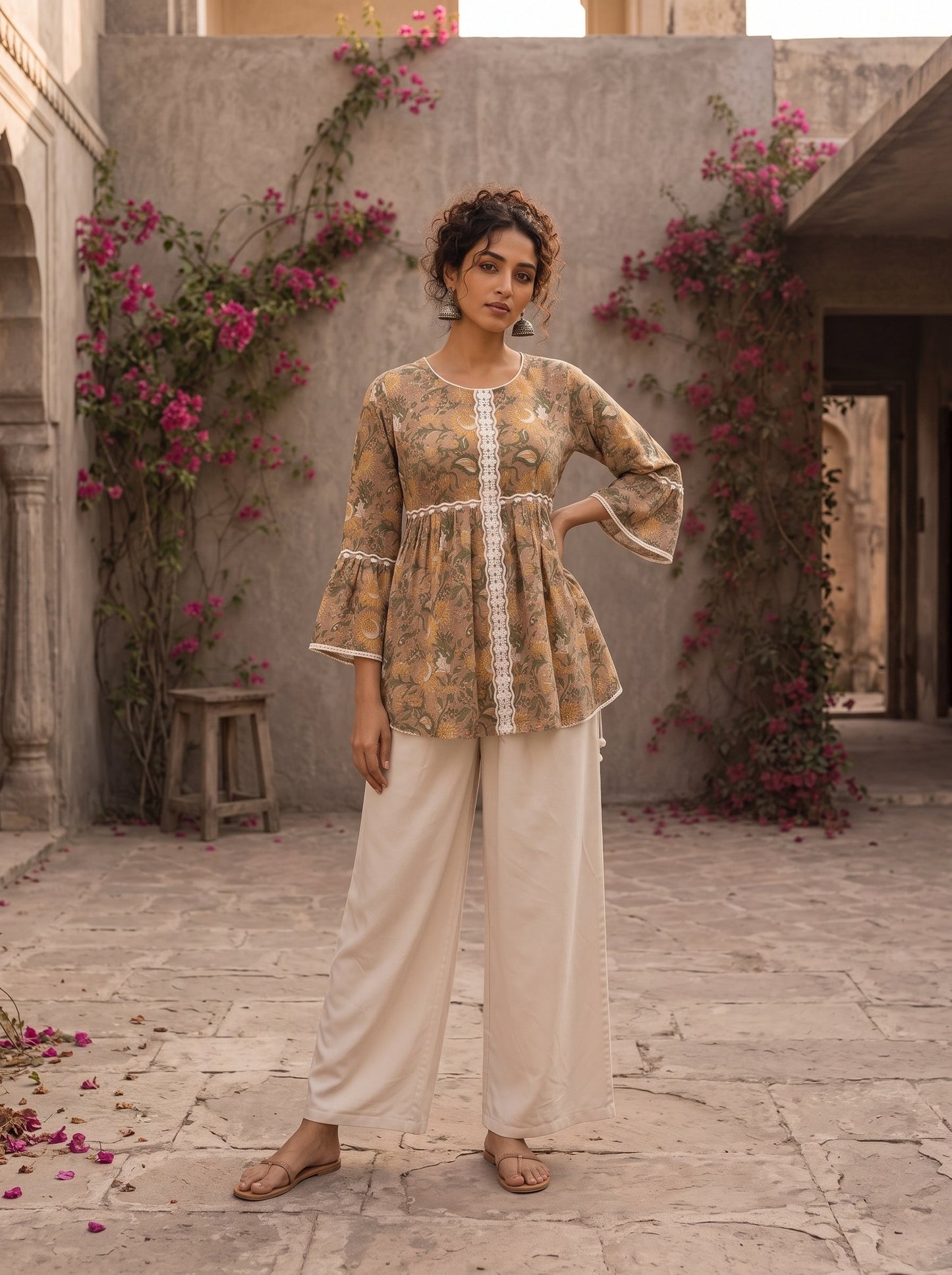 Romantic peach Jaipur floral top adorned with scalloped lace, gathered sleeve hems, and playful tie-knot accents.
