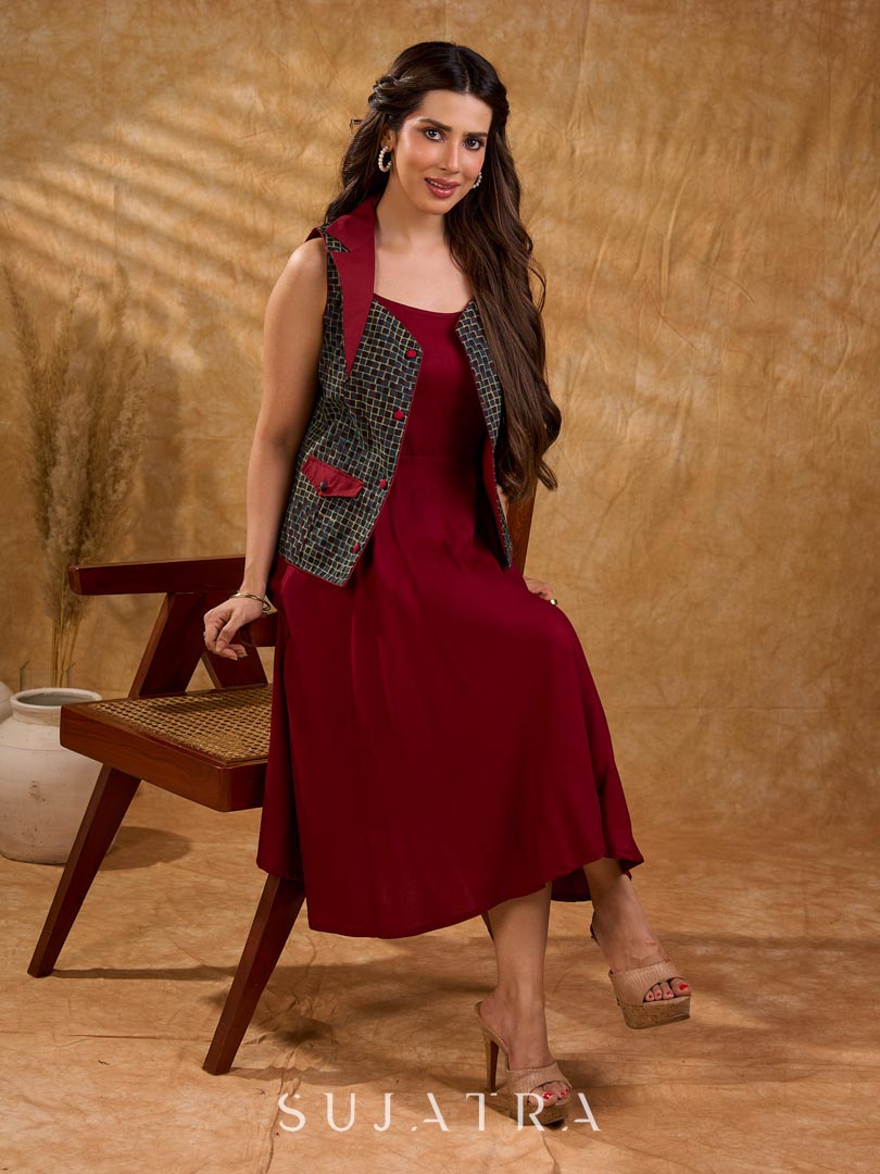 Sharp dark teal and maroon checkered sleeveless jacket with a distinctive notch collar and princess-cut tailoring, offering a structured silhouette ideal for elevated corporate styling.