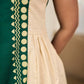 Bottle green and off-white hand block printed sleeveless dress with a block printed geometric panel, pearl embellishments, and refined accents for a contemporary artisanal look.