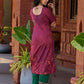 Exquisite deep burgundy printed kurta with intricate neck panel embroidery, delicate green beads, and refined green highlights.