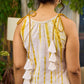 Sunlit ivory tie-dye dress with mustard accents and playful tassel shoulder detailing.