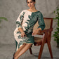 Bottle green and beige half and half dress with raglan sleeves and transitioning floral motifs.
