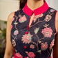 Elegant black Kalamkari dress featuring blooming florals and contrasting pink detailing for refined charm.