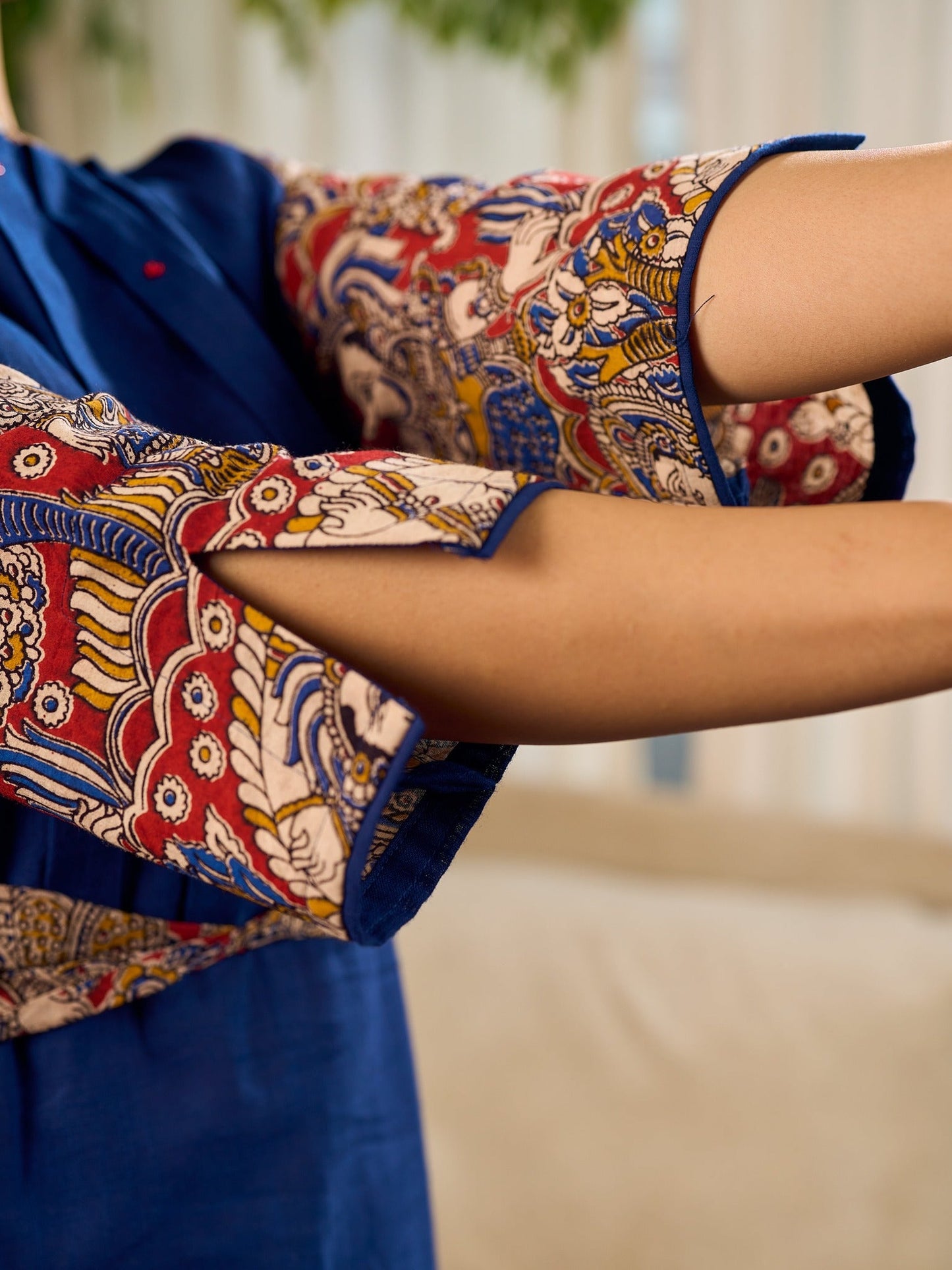 Navy Blue Artisanal Kalamkari prints enhanced with statement sleeves and a waist-defining knotted Kalamkari belt.