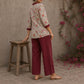 Soft white floral cotton top finished with maroon cuffs, pleated collar, and delicate feminine elegance.