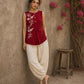 Charming red hand block print top showcasing elegant floral motifs, a contemporary pleated silhouette, and refined detailing, blending artisanal craftsmanship with effortless everyday style.