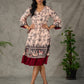 Beige traditional printed dress with rich maroon accents.