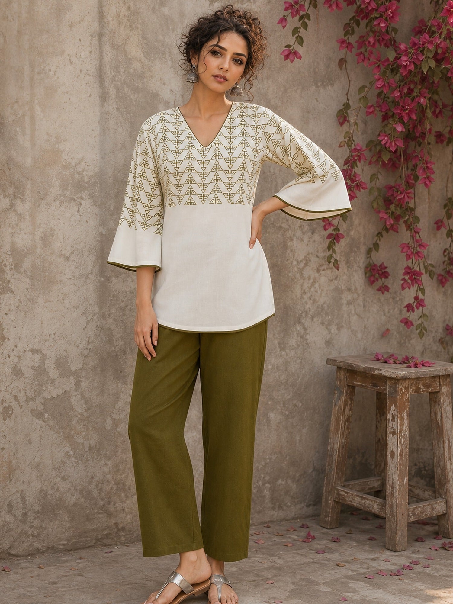 Contemporary off white and olive hand block print top features subtle geometric motifs, airy bell sleeves, and effortless elegance for versatile everyday styling.