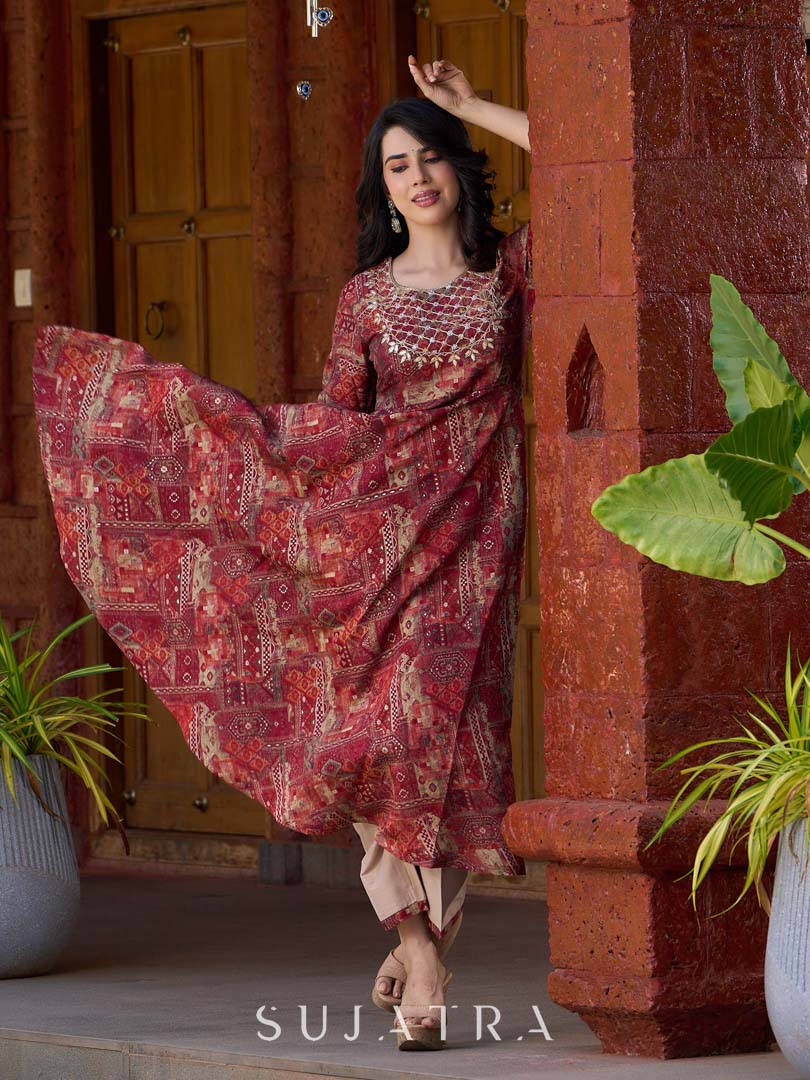 Exquisite deep maroon printed kurta with a graceful bias silhouette, intricate handwork on the yoke, and scalloped sleeve detailing.